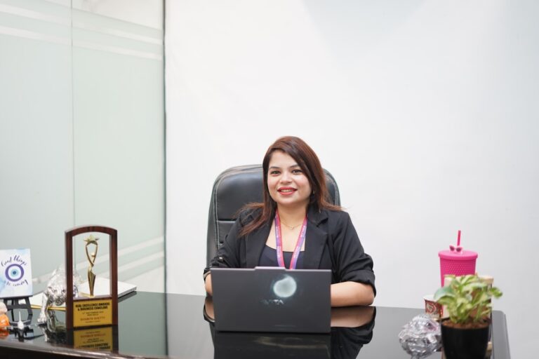 Uma Mulher Sorridente Esta Sentada Em Uma Mesa Com Um Laptop 5k3VgWVyqbM