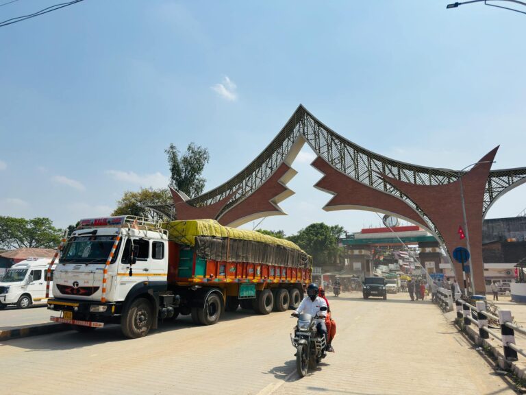 A lively street scene featuring vehicles near an iconic gate in Butwal, Nepal.