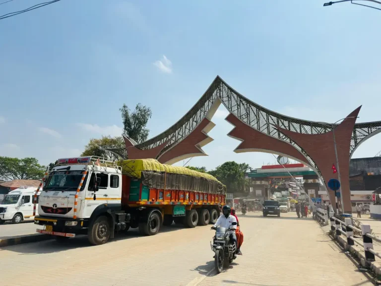 A lively street scene featuring vehicles near an iconic gate in Butwal, Nepal.