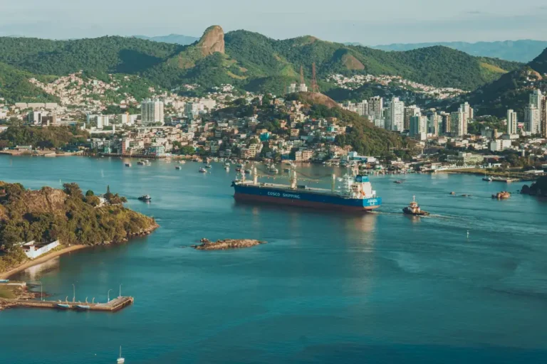 A stunning aerial view of Salvador harbor featuring a cargo ship and surrounding cityscape.